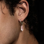 Man wearing a Masterblade talisman earring in a side view